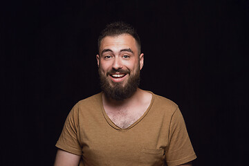 Image showing Close up portrait of young man isolated on black studio background