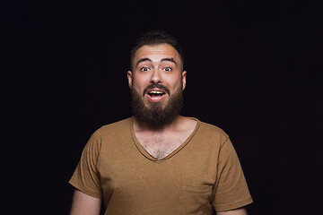 Image showing Close up portrait of young man isolated on black studio background