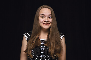 Image showing Close up portrait of young woman isolated on black studio background