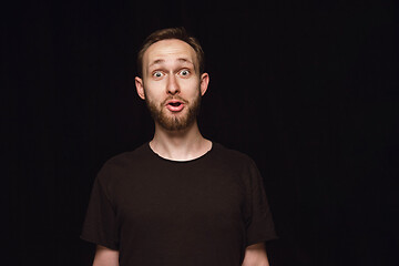 Image showing Close up portrait of young man isolated on black studio background