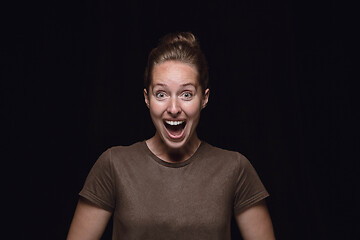 Image showing Close up portrait of young woman isolated on black studio background