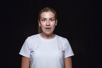 Image showing Close up portrait of young woman isolated on black studio background