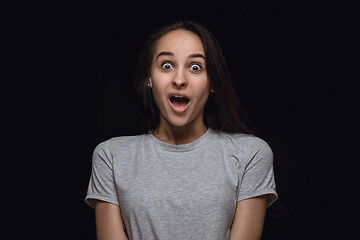 Image showing Close up portrait of young woman isolated on black studio background