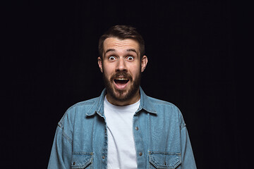 Image showing Close up portrait of young man isolated on black studio background