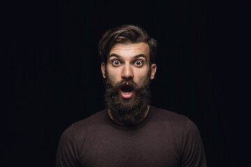 Image showing Close up portrait of young man isolated on black studio background