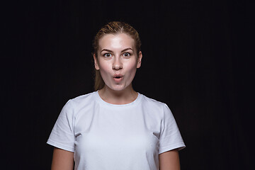 Image showing Close up portrait of young woman isolated on black studio background