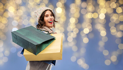 Image showing woman in hat with shopping bags on christmas