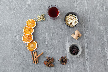 Image showing hot mulled wine, orange slices, raisins and spices