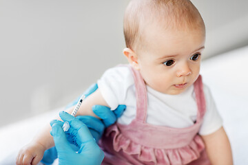 Image showing doctor making vaccine for baby patient at clinic