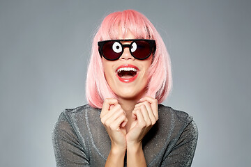 Image showing happy woman in pink wig and black sunglasses