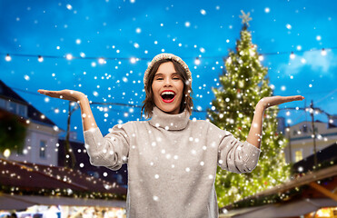 Image showing happy woman in hat at christmas market