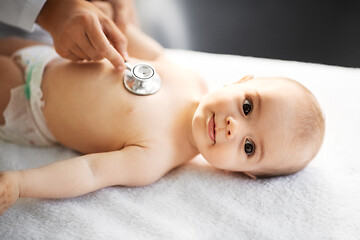 Image showing doctor with stethoscope listening to baby patient