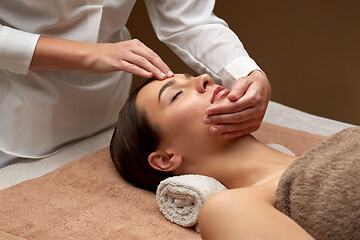 Image showing woman having face and head massage at spa