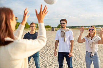 Image showing friends playing volleyball on beach in summer