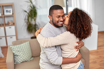 Image showing happy african american couple kissing at home