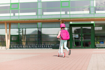 Image showing school girl with backpack riding scooter