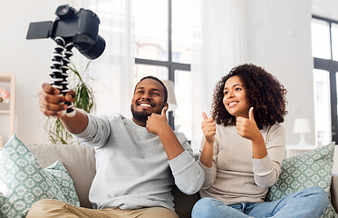 Image showing couple of video bloggers with camera at home