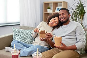 Image showing happy couple with takeaway food and drinks at home