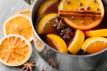 Image showing pot with hot mulled wine, orange slices and spices