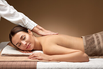 Image showing woman lying and having back massage at spa