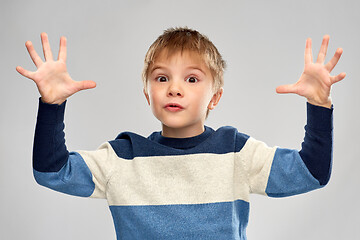 Image showing portrait of little boy in striped pullover playing