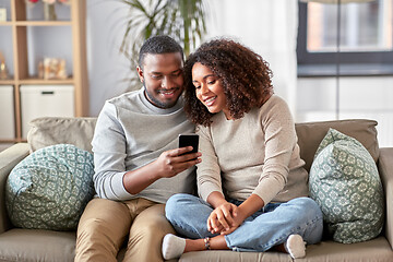 Image showing african american couple with smartphone at home