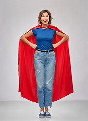 Image showing happy woman in red superhero cape