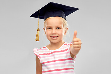 Image showing little girl in mortarboard showing thumbs up