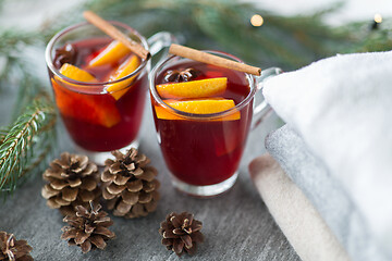 Image showing mulled wine with orange and spices, cones and fir