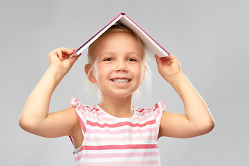 Image showing little girl with roof of book on top of her head