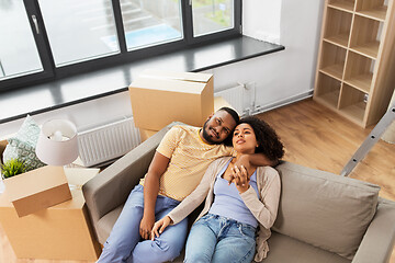 Image showing happy couple with boxes moving to new home