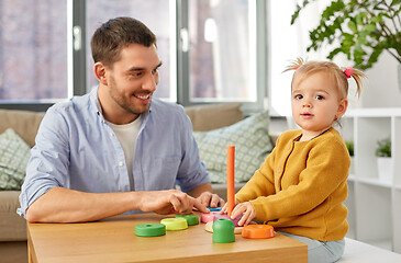 Image showing father playing with little baby daughter at home