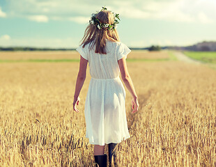 Image showing happy young woman in flower wreath on cereal field