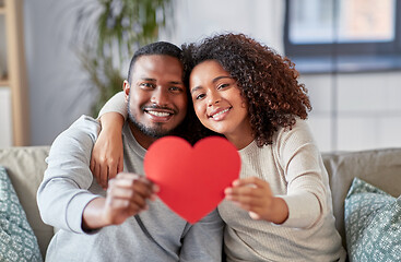 Image showing happy african american couple with heart at home