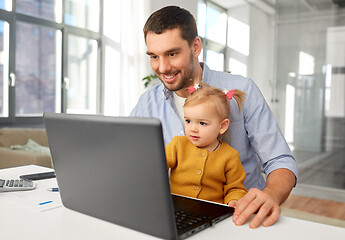 Image showing working father with baby daughter at home office