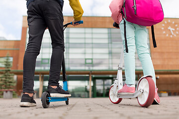 Image showing school children with backpacks and scooters