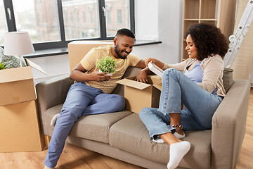 Image showing happy couple with boxes moving to new home