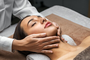Image showing woman having face and head massage at spa