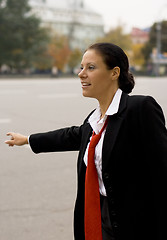 Image showing hitchhiking businesswoman 