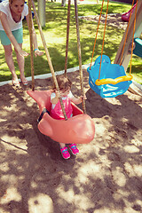 Image showing mother and daughter swinging in the park