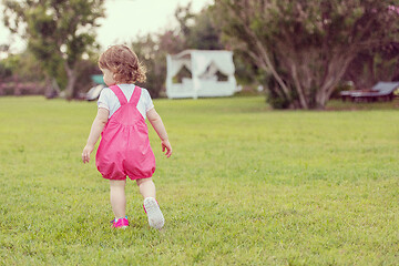 Image showing little girl spending time at backyard