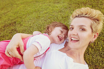 Image showing mother and little daughter playing at backyard