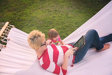 Image showing mom and a little daughter relaxing in a hammock