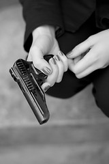 Image showing gun in female hands