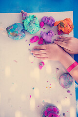 Image showing kid hands Playing with Colorful Clay