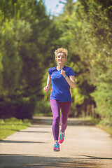 Image showing young female runner training for marathon