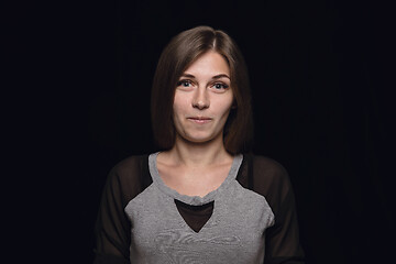 Image showing Close up portrait of young woman isolated on black studio background