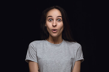 Image showing Close up portrait of young woman isolated on black studio background