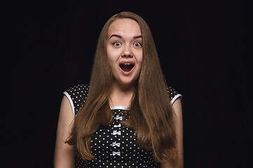 Image showing Close up portrait of young woman isolated on black studio background