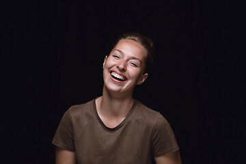 Image showing Close up portrait of young woman isolated on black studio background